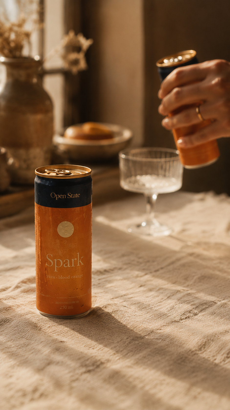 Open State Spark can beside a coupe glass at five o'clock